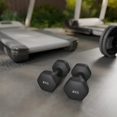 Two 8kg dumbbells are in the foreground, with treadmills in the background.