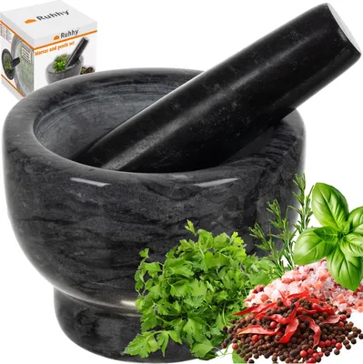 A marble mortar and pestle set with herbs and spices.