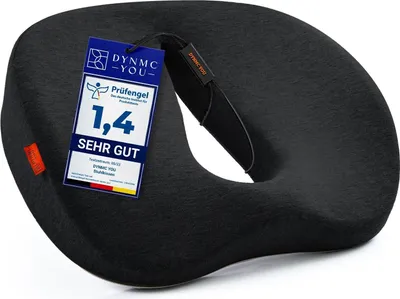 A black donut-shaped cushion with a tag attached.