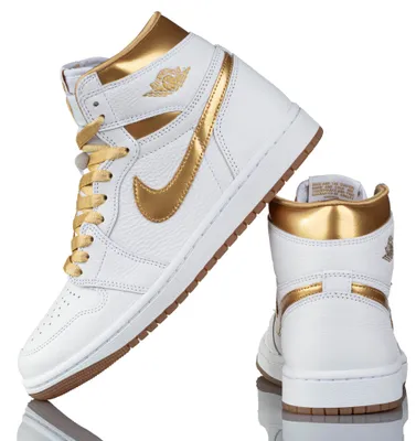 A pair of white and gold Nike Air Jordan 1 Retro High sneakers are displayed against a white background.