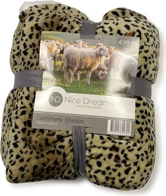 A folded leopard print blanket with a product label attached.