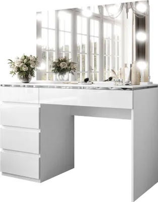 A white vanity table with a mirror and lights, decorated with flowers and makeup items.