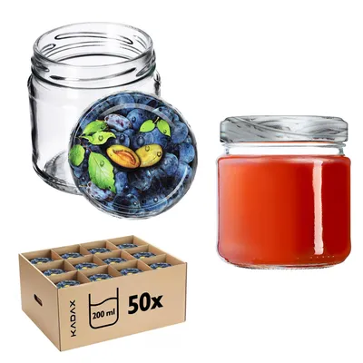 A collection of glass jars, some empty, one filled with red liquid, and a carton of smaller jars.