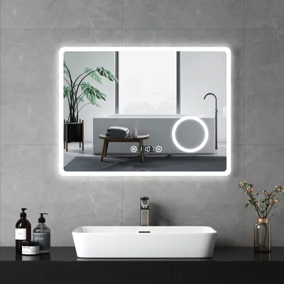 A modern bathroom with a large LED mirror above a sink.