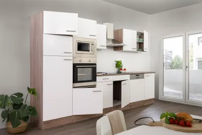 A modern, white and wood-tone kitchen unit with appliances.