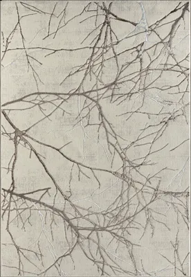 A close-up view of a rug with a branch pattern.