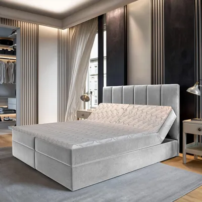 A modern bedroom with a boxspring bed.