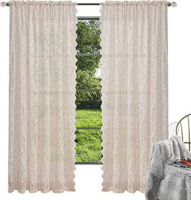 Two lace curtains hanging in a window with a view of greenery outside. A chair with a blanket is visible on the right.