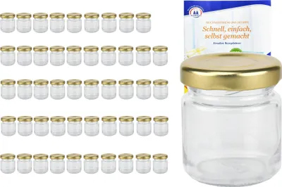A set of small glass jars with gold lids, along with a recipe booklet.