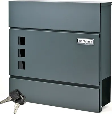 A dark gray modern mailbox with a newspaper compartment and two keys in the foreground.
