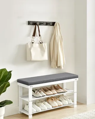 An entryway with a shoe bench and a coat rack.