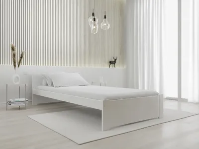 A minimalist bedroom scene featuring a white bed.