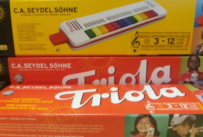 Three boxes of C.A. Seydel Söhne Triola musical instruments for children.