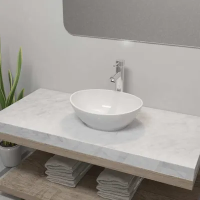 A bathroom vanity with a white ceramic sink and a chrome faucet.