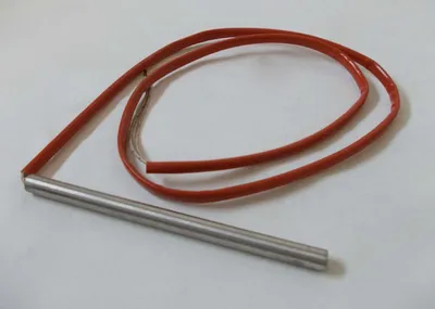 A heating element with a red insulated wire on a white background.