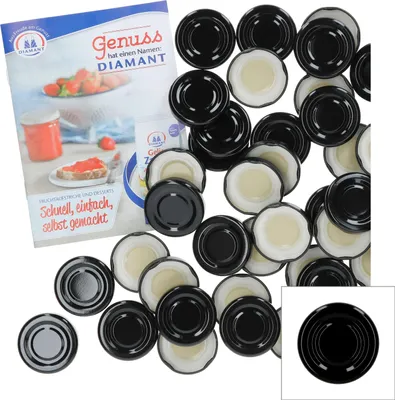 A collection of black and white jar lids, with a brochure in the background.