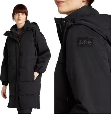 A woman wearing a black puffer jacket, with a close-up of the jacket's sleeve showing the brand logo.
