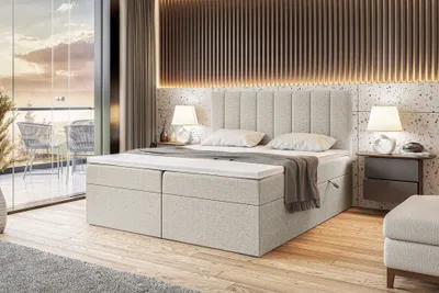 A modern bedroom scene with a boxspring bed.