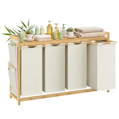 A laundry hamper with four compartments and a shelf on top, decorated with toiletries and towels.