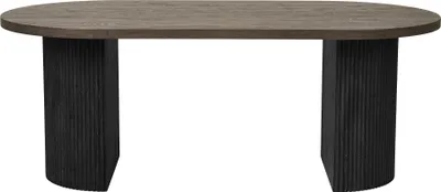 A table with an oval wooden top and two black fluted pedestal legs.