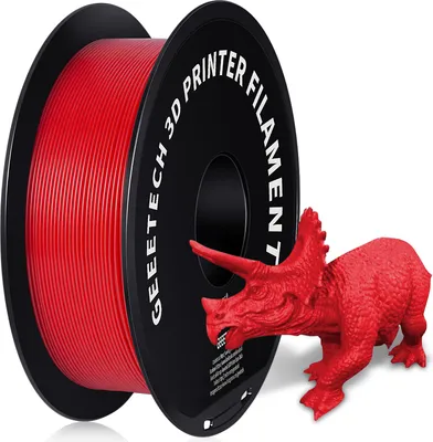 A spool of red 3D printer filament is shown next to a red 3D printed triceratops dinosaur.