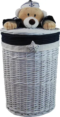 A white wicker laundry basket with a lid decorated with a plush bear wearing a sailor hat.
