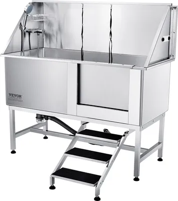 A professional studio shot of a stainless steel dog grooming bathtub with attached steps.