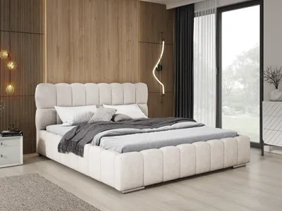 A bedroom scene featuring a large upholstered bed.