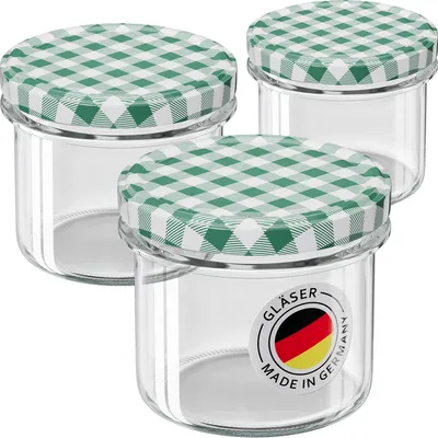 Three glass jars with green checkered lids are arranged in a group against a white background.