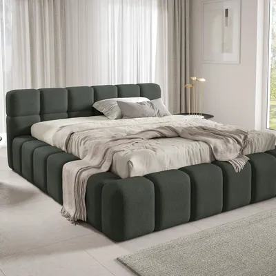 A bed with bedding in a room.