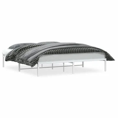A white metal bed frame with bedding.