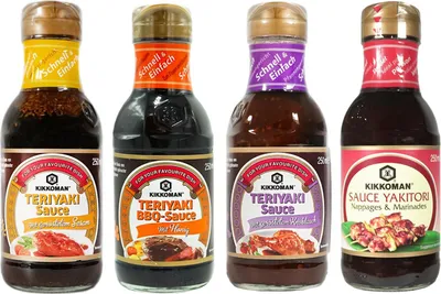 Four bottles of Kikkoman sauces are displayed side-by-side against a white background.