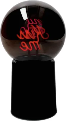 A black globe-shaped lamp with red neon light inside that spells out "Kiss me". The lamp is on a black base.