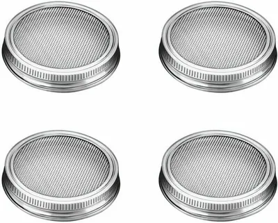 Four stainless steel lids for sprouting jars are arranged in a two-by-two grid on a white background.