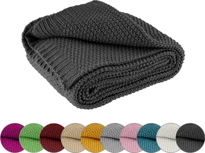 A folded dark gray knitted blanket is shown on a white background. Below the blanket, there are circular swatches of various colors, likely representing other available colors for the same product.