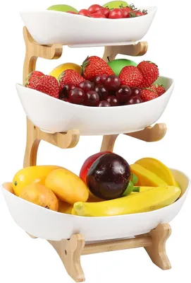 A three-tiered fruit stand filled with various fruits.
