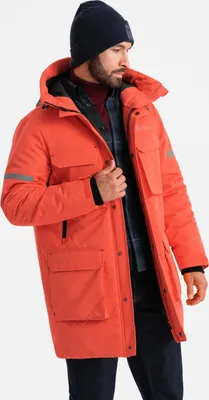 A man wearing a winter jacket, beanie, and turtleneck.