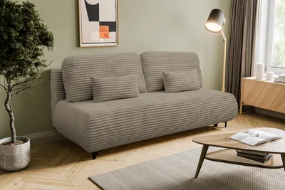 A living room scene featuring a sofa, coffee table, and plant.