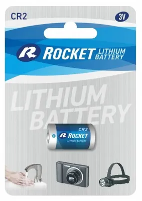 A product package for a ROCKET CR2 lithium battery, showing the battery and icons of devices it can power.