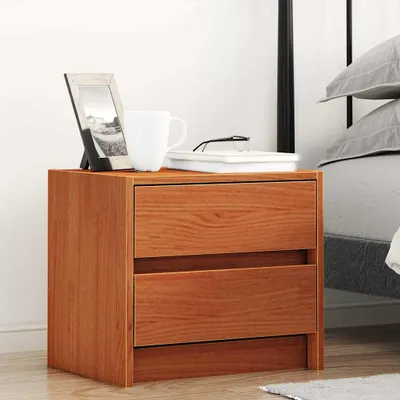 A wooden nightstand with two drawers next to a bed.