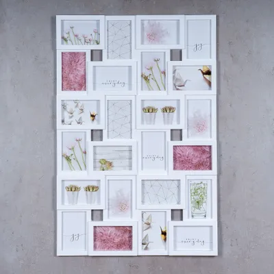A white collage picture frame filled with various photos of flowers, plants, and abstract designs, set against a gray concrete background.