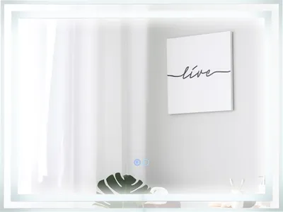A modern bathroom mirror with integrated LED lighting, reflecting a minimalist interior with a framed artwork and a plant.