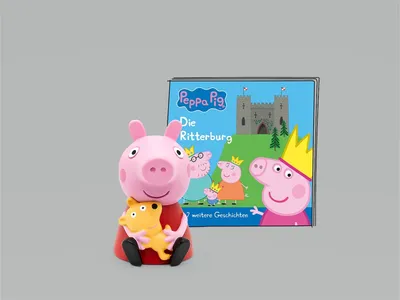 A Peppa Pig figurine and book are displayed against a plain gray background.