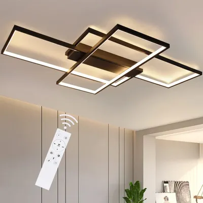 A modern geometric LED ceiling light fixture with a remote control shown in the foreground.