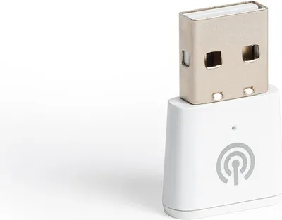 A white ZigBee signal amplifier with a USB connector is shown against a white background.