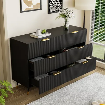 A black sideboard with gold accents is shown in a room with a window and a plant.
