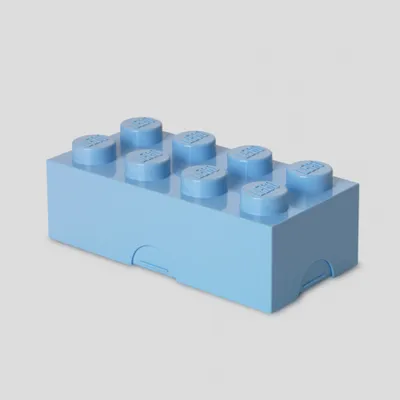 A light blue LEGO snack box is shown against a light gray background.