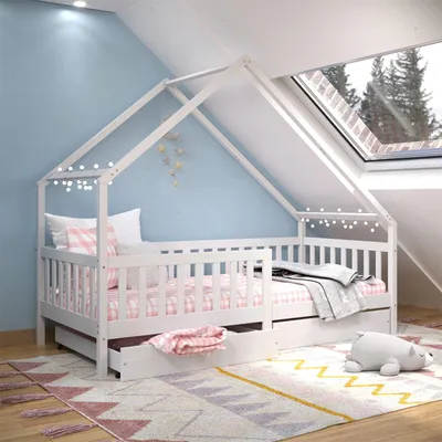 A child's bedroom with a house-shaped bed under a skylight.