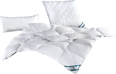 A white duvet and two white pillows are arranged on a white background.