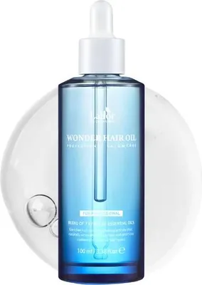 A bottle of La'dor Wonder Hair Oil with a dropper, presented on a white background with a clear liquid overlay.